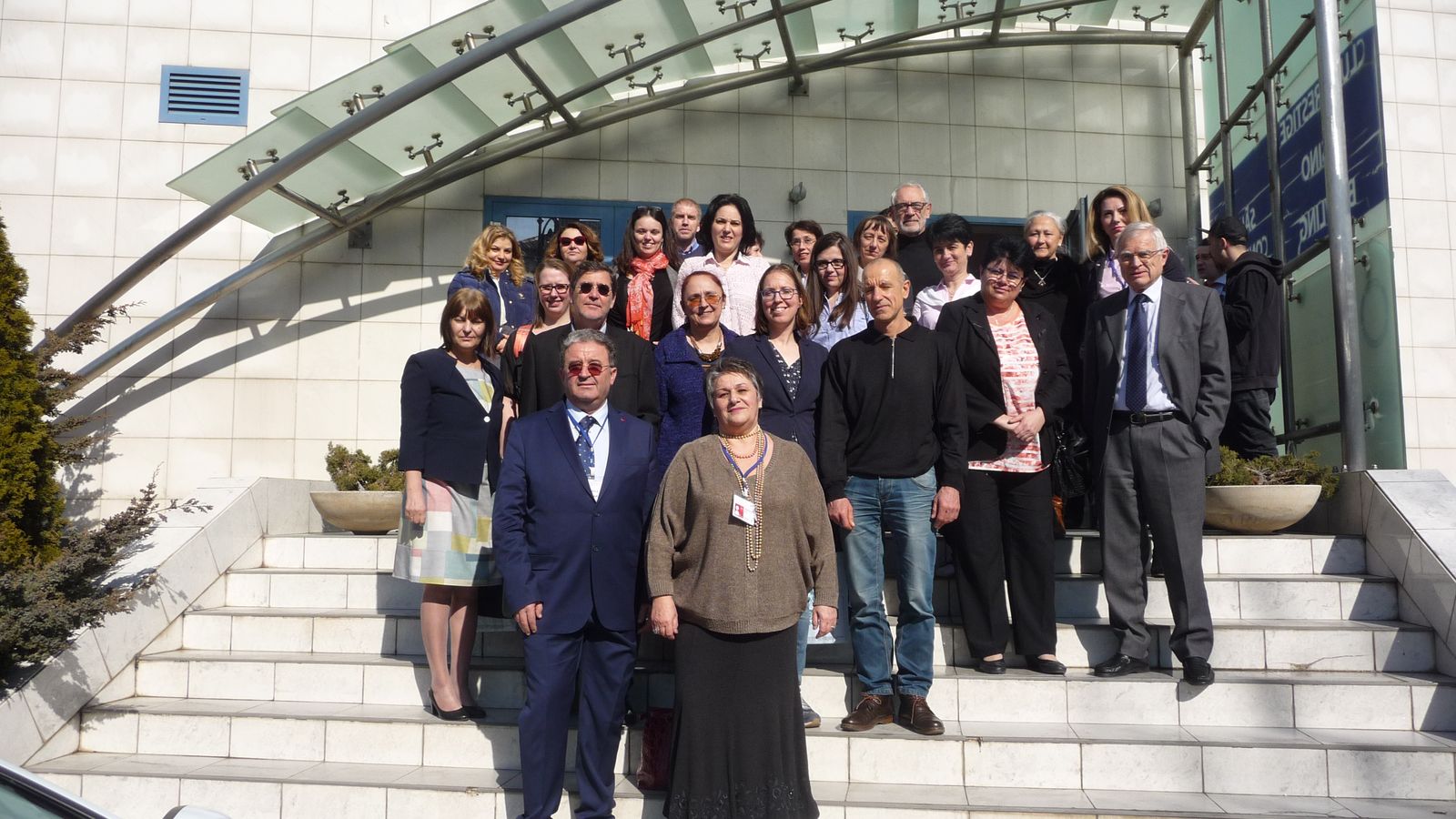 Participants of an ELICIT+ course on the steps of a building
